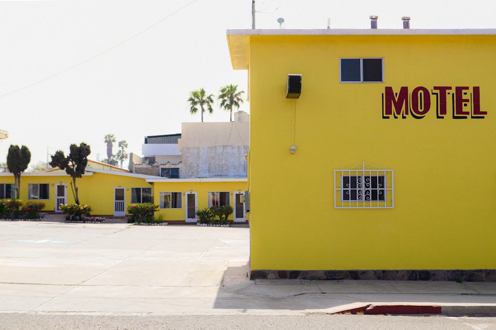 a yellow building with a motel sign on the side of it