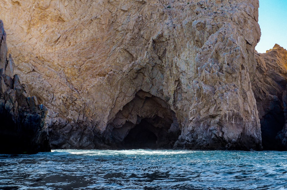 a large rock formation in the middle of a body of water