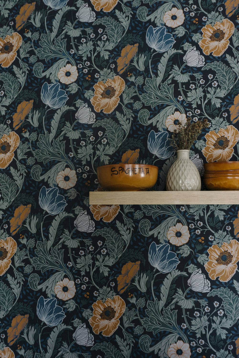 a shelf with two vases on top of it