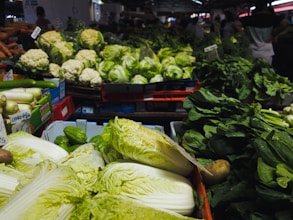 a produce section of a grocery store filled with fresh vegetables