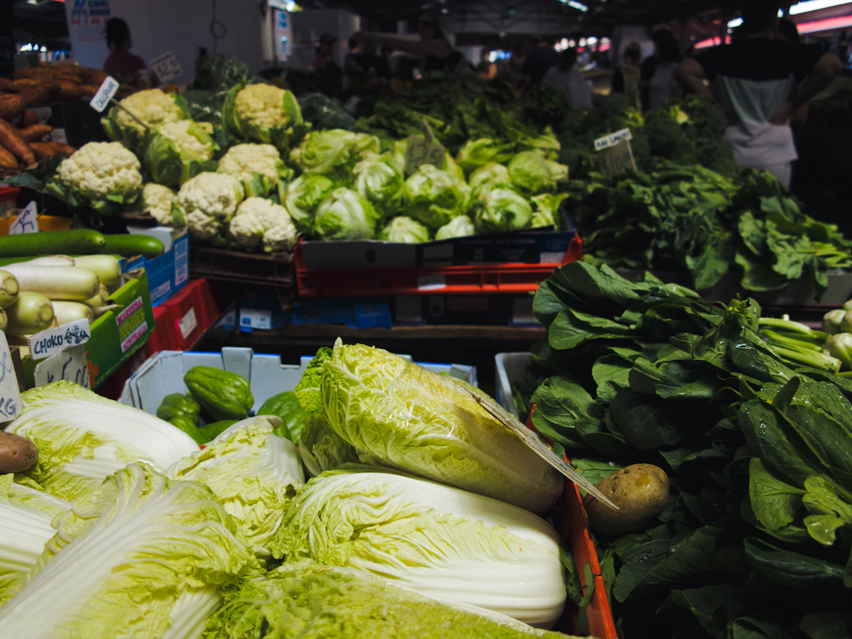 A produce section of a grocery store filled with fresh, colorful vegetables.