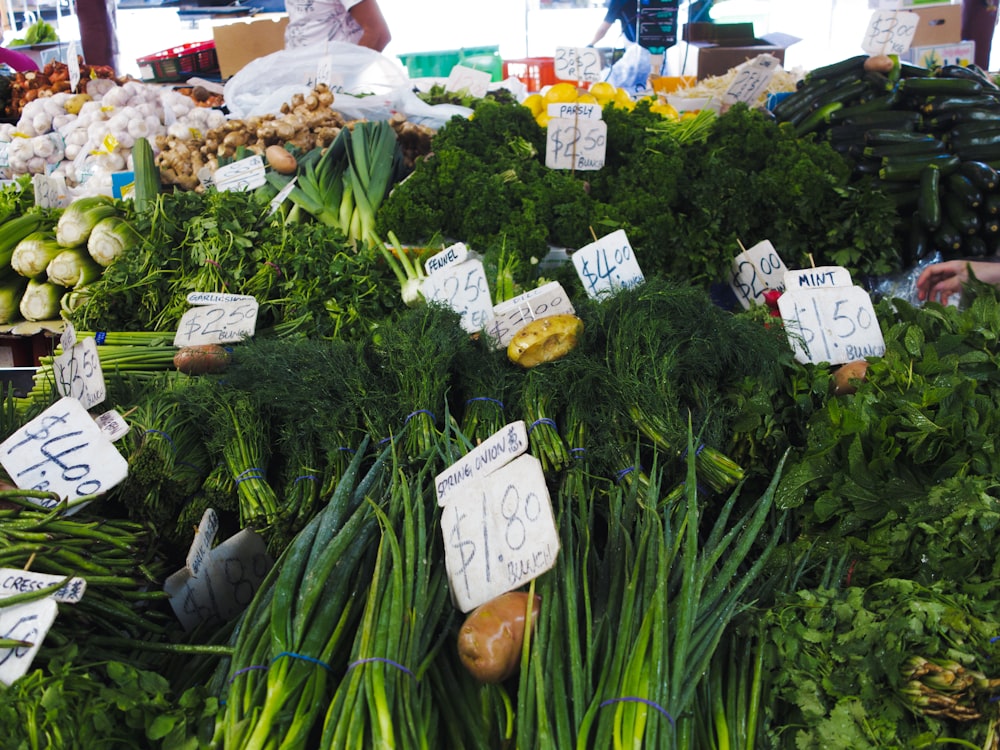 a bunch of vegetables are on display at a market