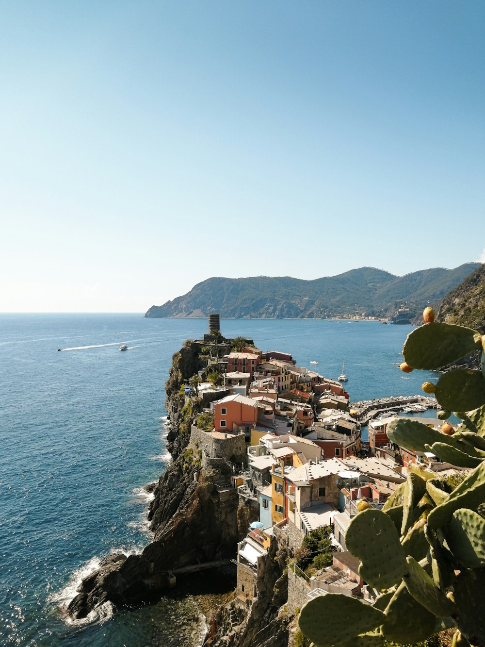 a small village on the edge of a cliff next to the ocean