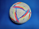 A vibrant digital artwork showing a soccer ball merging with futuristic tech elements.