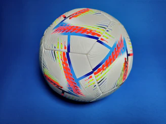 A vibrant collage showing a soccer ball, cricket bat, and basketball with live scoreboards in the background.