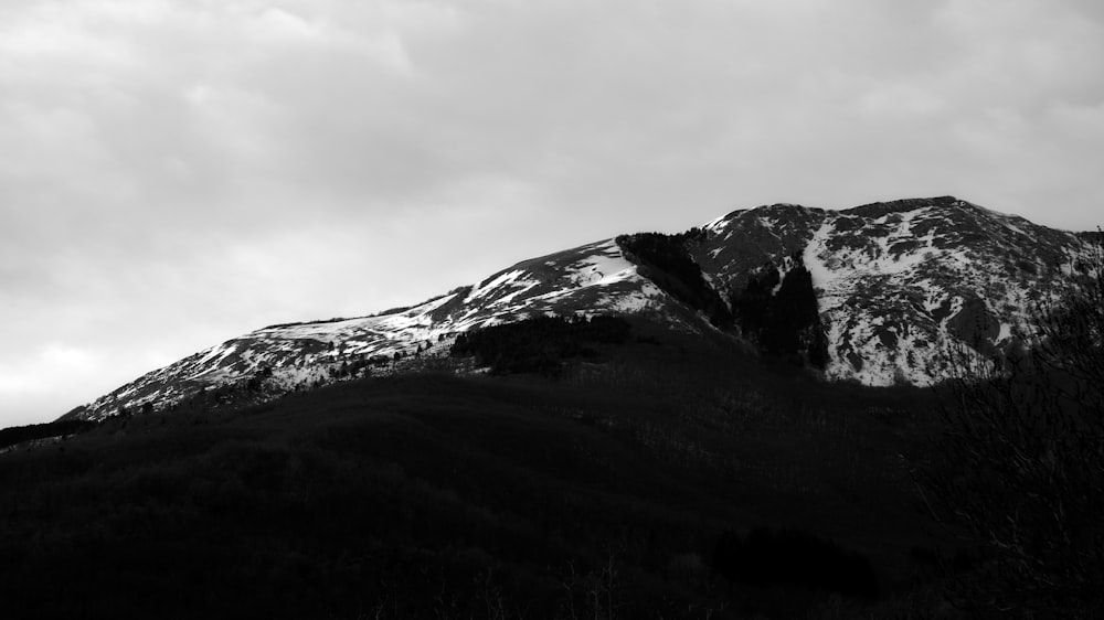 a black and white photo of a snow covered mountain