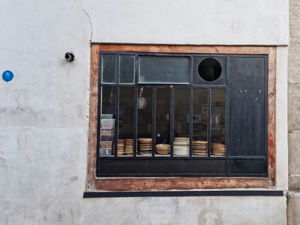 a window that has a bunch of plates in it