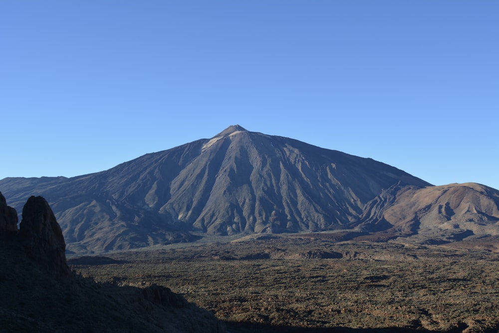 a view of a mountain with a clear blue sky