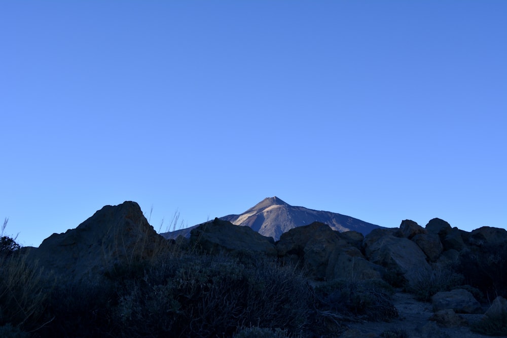 a view of a mountain with a blue sky