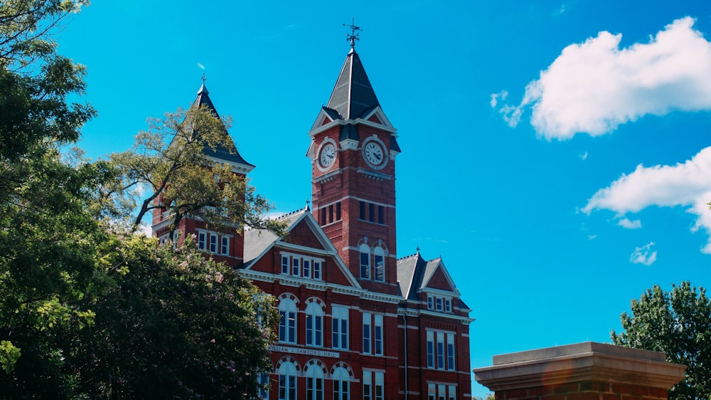 a large red brick building with a clock tower