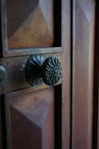 Close-up of the house’s wooden door with vintage ironwork details.