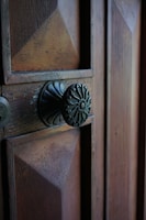A before-and-after shot of a repaired vintage door with intricate hardware restored.