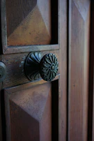Close-up of a vintage door with restored metalwork and fresh paint.