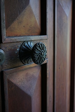 Close-up of the house’s wooden door with vintage ironwork details.