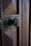 Close-up of a bronze door knob on a wooden farmhouse door with soft natural light.
