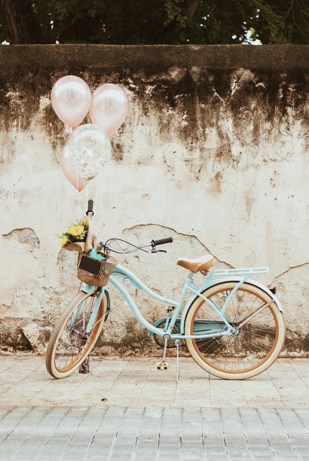 a blue bicycle with balloons attached to it
