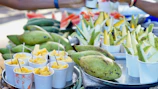 Close-up of hands sorting fresh exotic fruits on a wooden table.