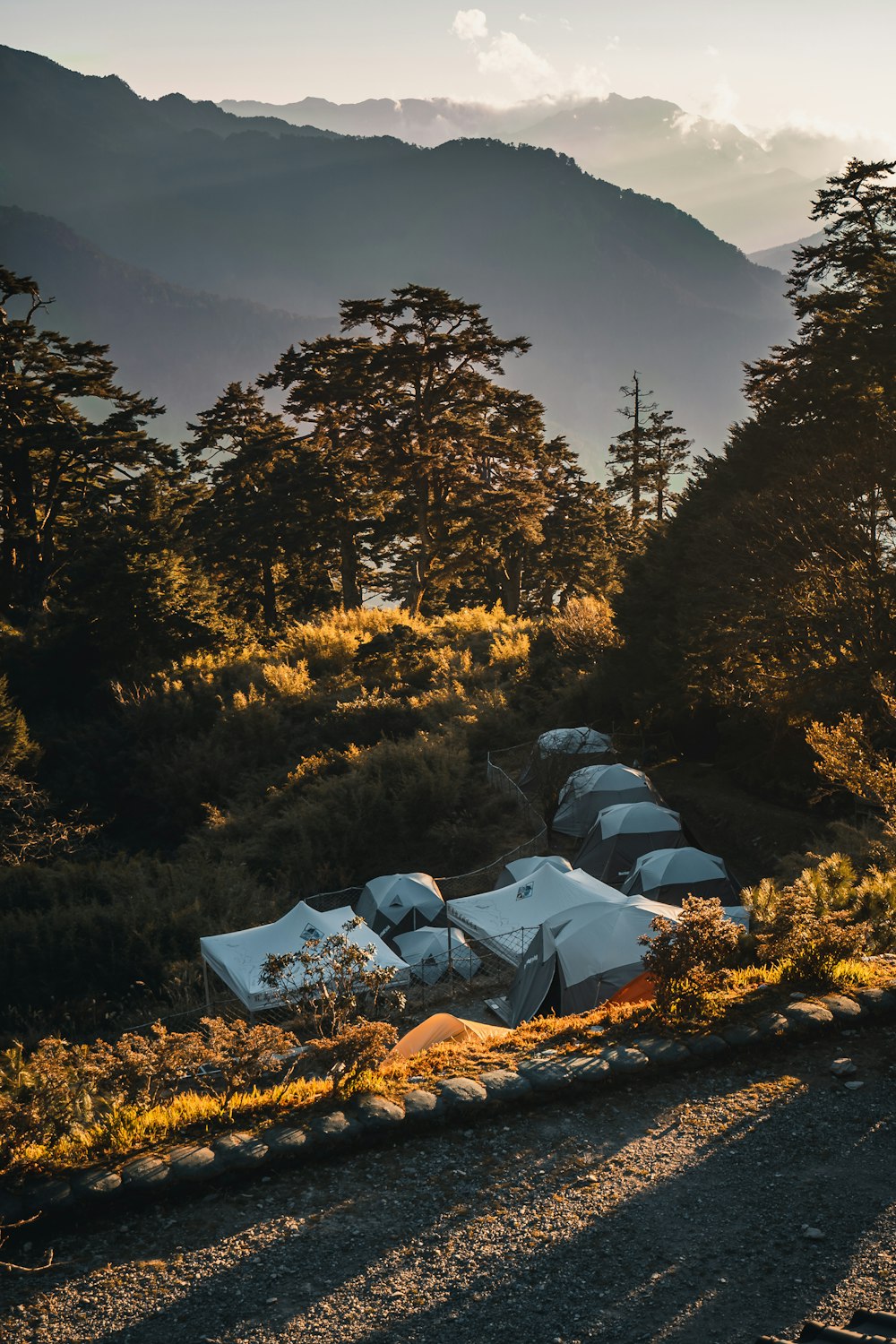 a group of tents sitting on top of a lush green hillside
