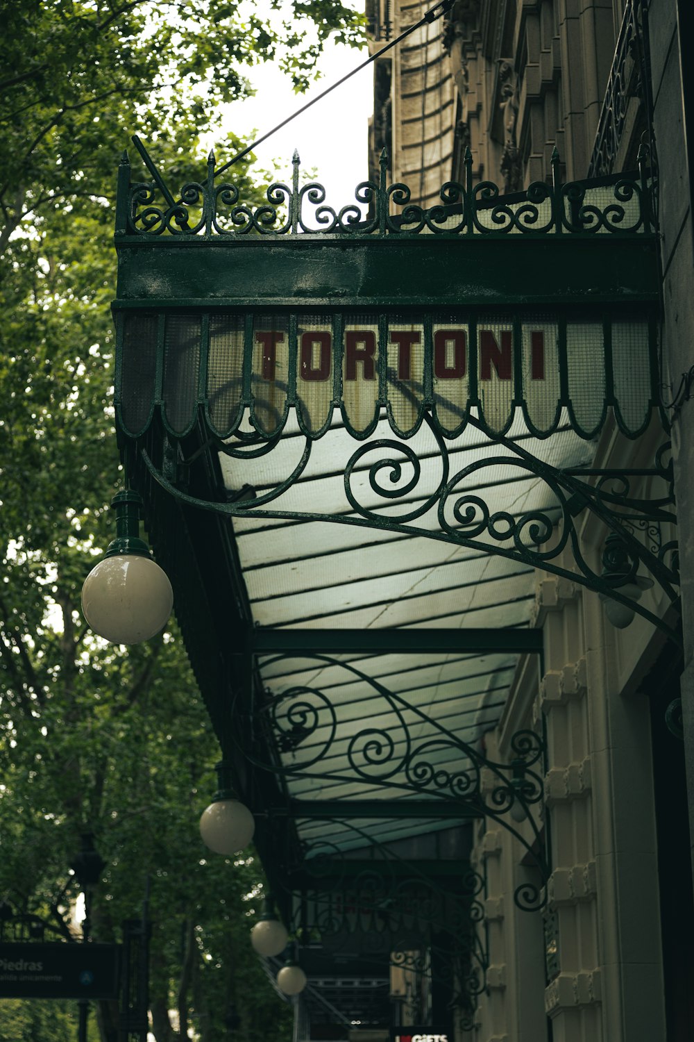 a street sign hanging from the side of a building