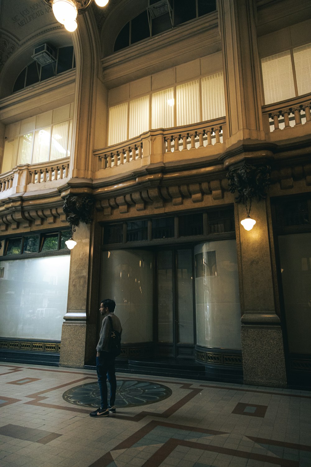 a man standing in front of a tall building