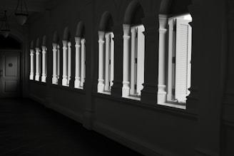 a black and white photo of a row of windows
