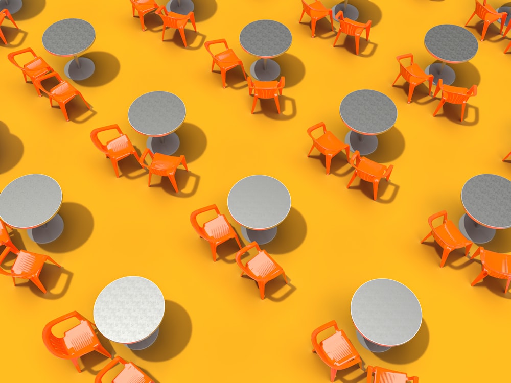 a group of orange chairs and tables sitting next to each other