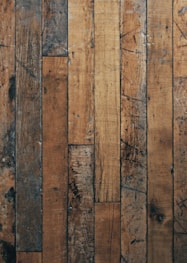 a close up of a wooden floor with peeling paint
