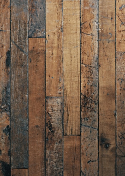 a close up of a wooden floor with peeling paint