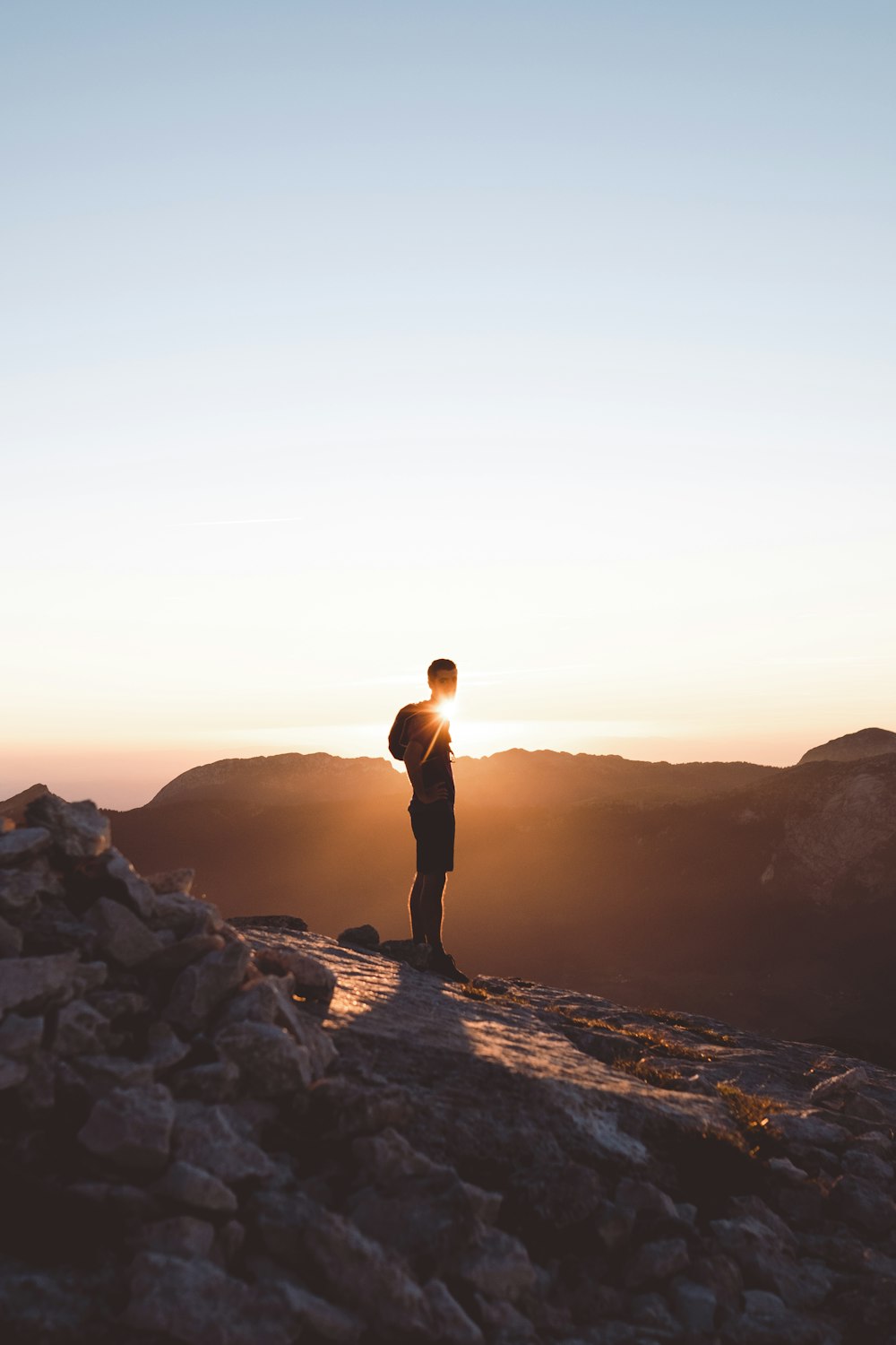 a man standing on top of a rocky mountain