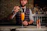 Elegant bartender crafting a signature cocktail at a luxurious private event.
