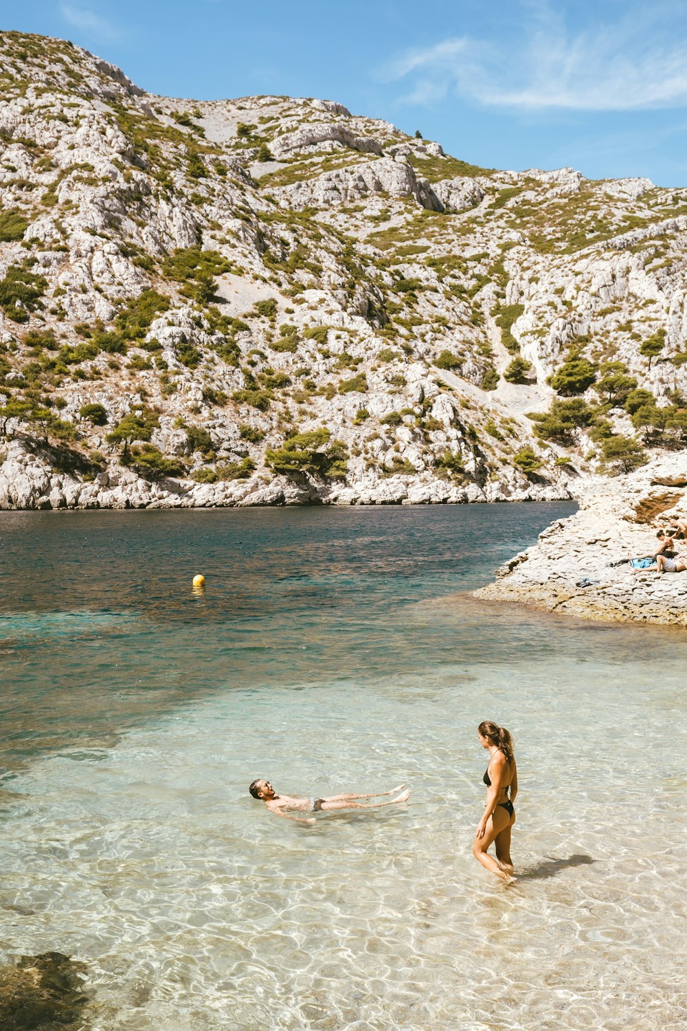 a man and a woman wading in the water