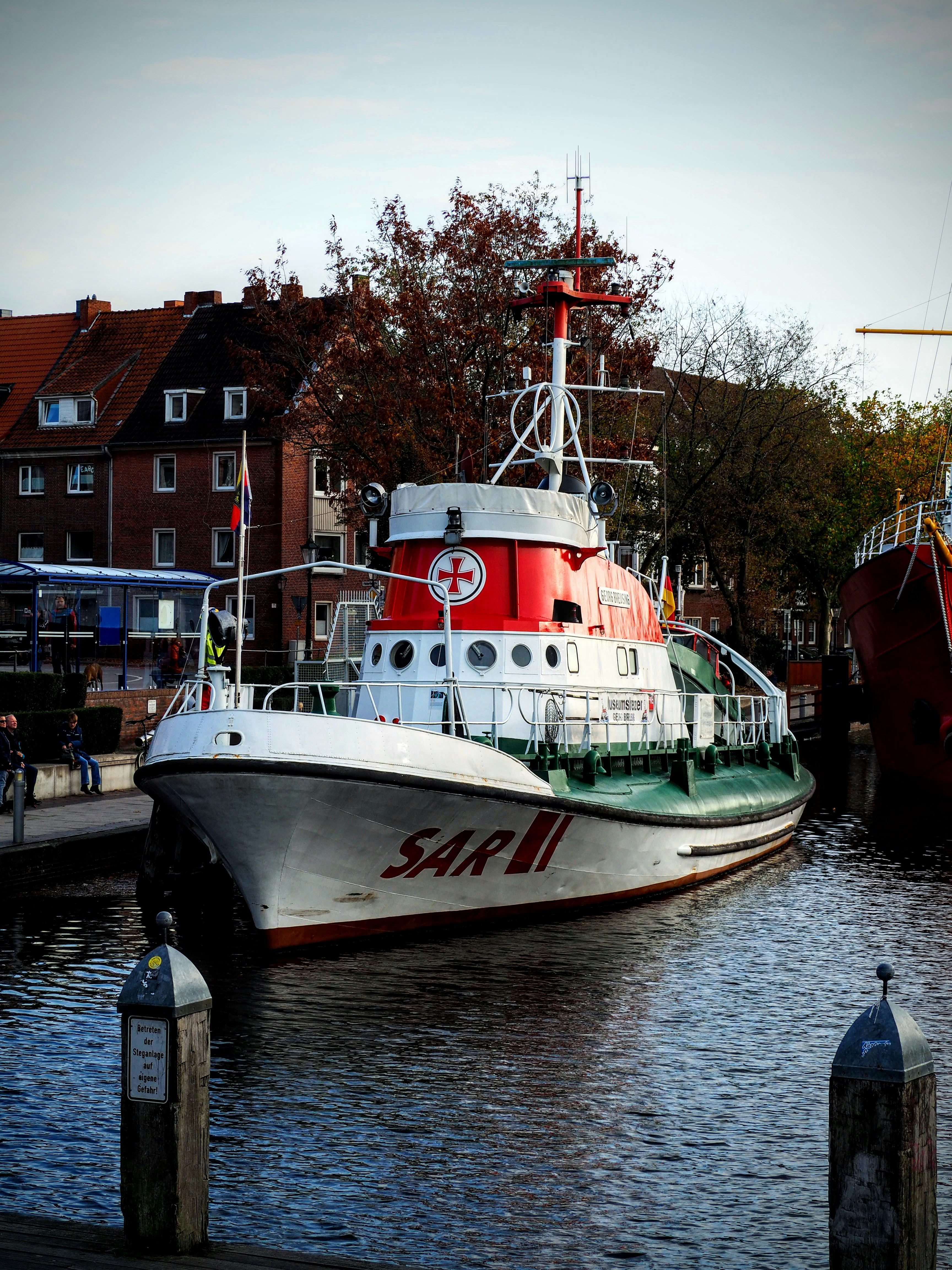 a red and white boat in a body of water