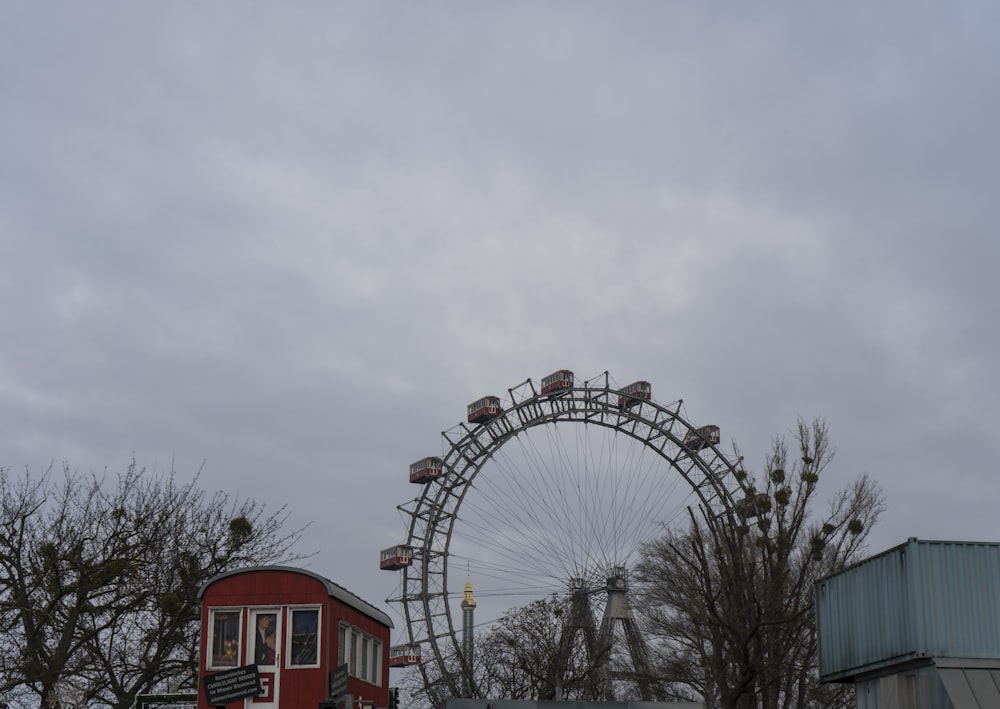 a ferris wheel and a red building in the background