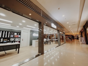 Customer service representative assisting a client with iPhone accessory options in a bright, modern store.