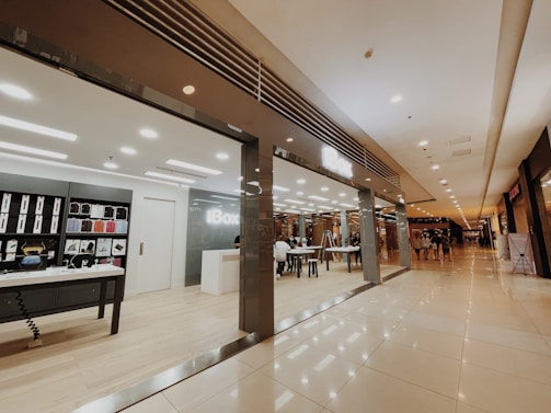 A sleek kiosk with colorful displays attracting customers in a spacious mall.