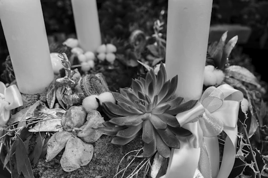 Close-up of elegant event accessories including ribbons, candles, and decorative items.