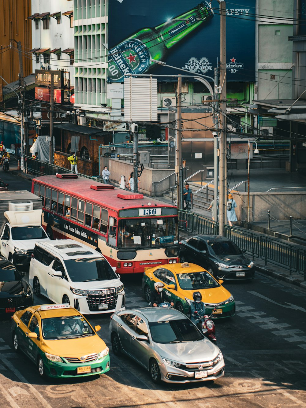 a city street filled with lots of traffic next to tall buildings