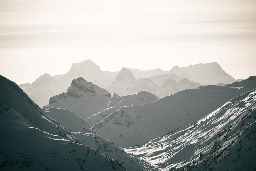 a mountain range with snow covered mountains in the background