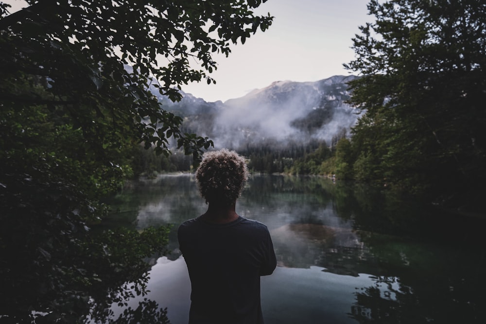 a person standing in front of a body of water