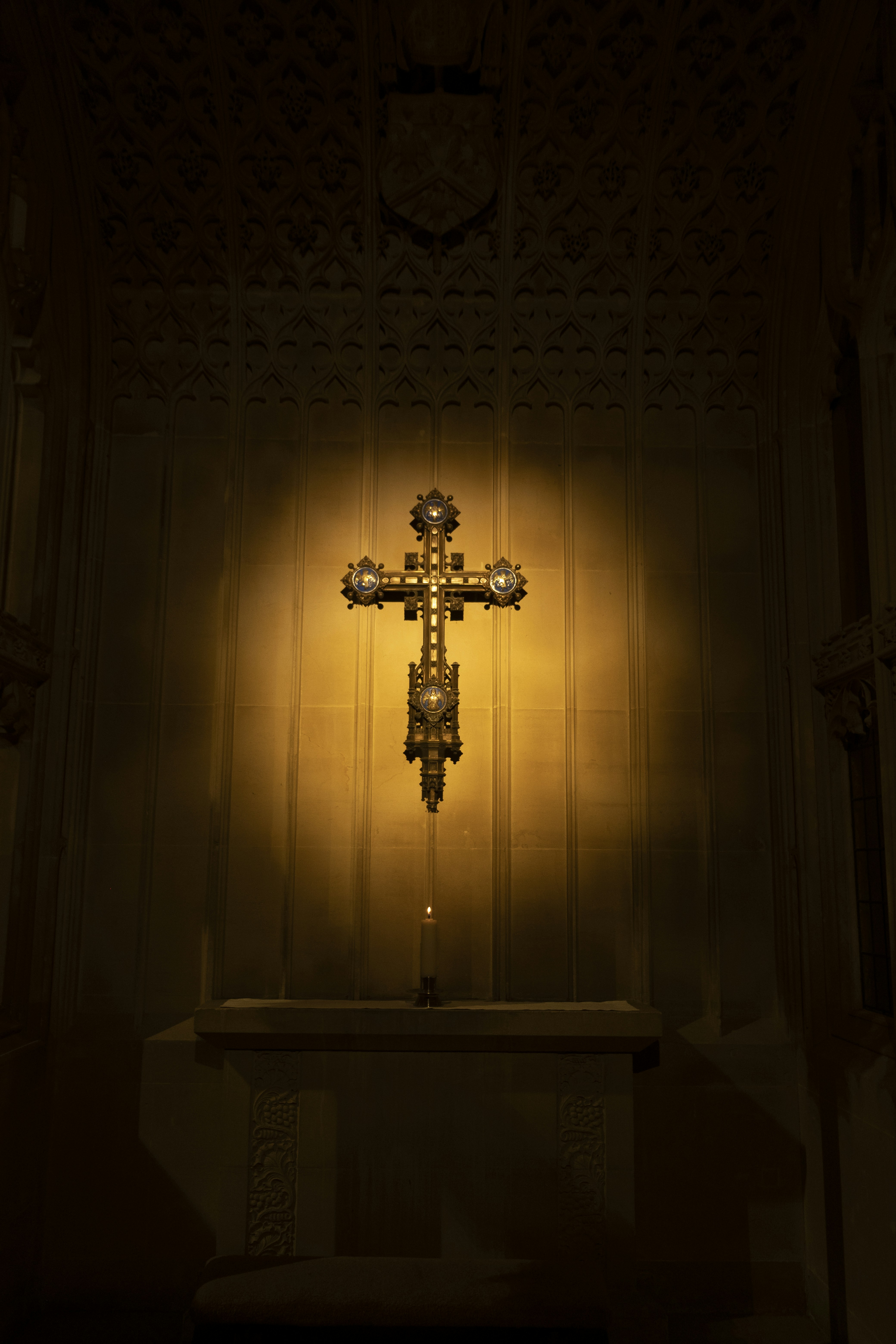 a cross on a table in a dimly lit room
