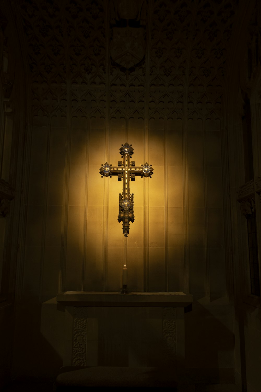 a cross on a table in a dimly lit room