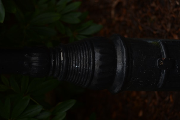 Close-up of chemical earthing setup with pipes and plates embedded in the ground.