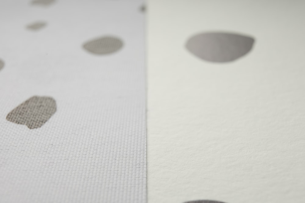 a close up of a white and gray polka dot paper