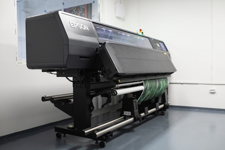 Large industrial printers working simultaneously on multiple orders in a spacious facility