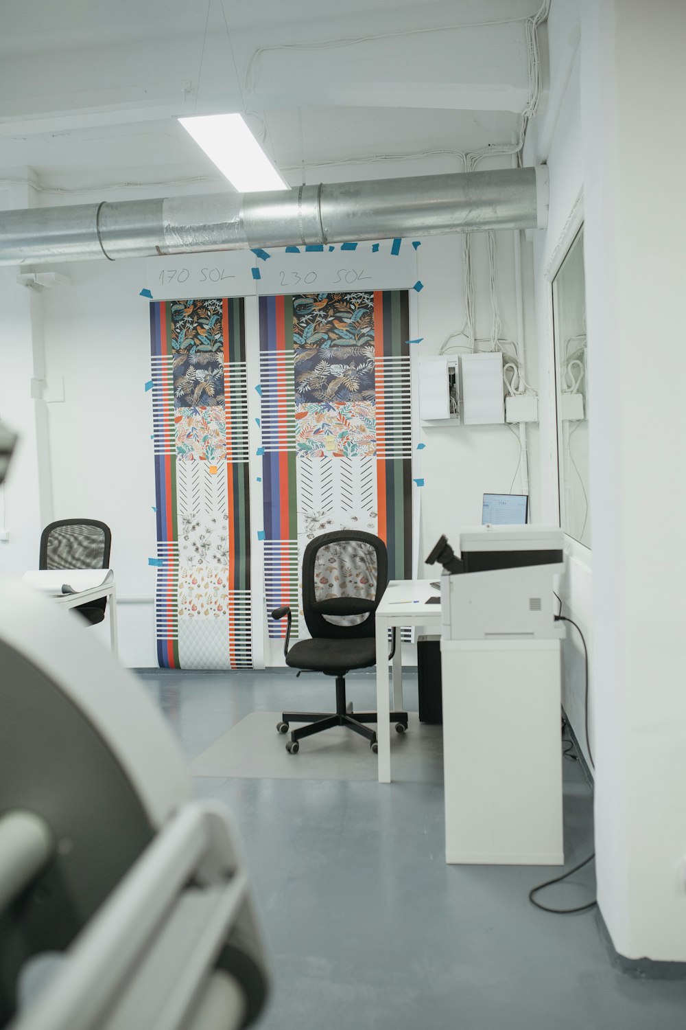 a room with a chair, desk, and computer