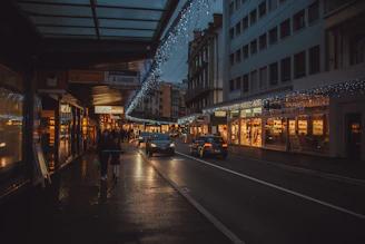a city street filled with lots of traffic next to tall buildings