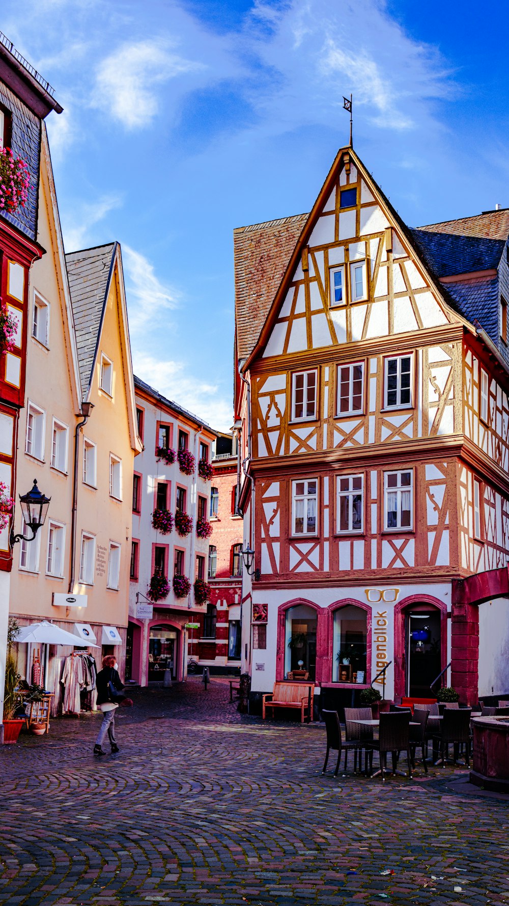 a cobblestone street lined with tall buildings