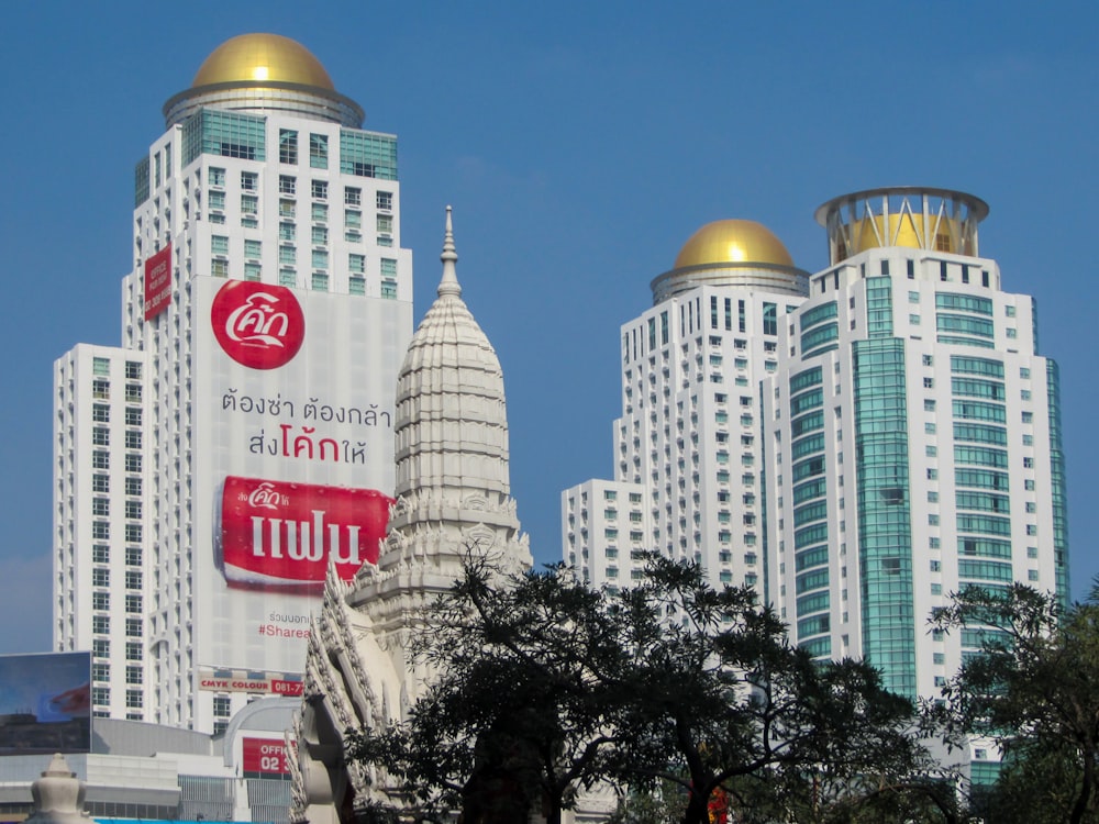 a group of tall white buildings with gold domes