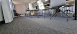 A modern conference room showcasing carpet tiles and wallpaper in a light luxury theme.
