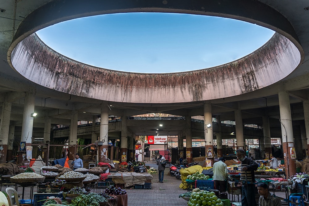 the inside of a market with lots of fruit and vegetables
